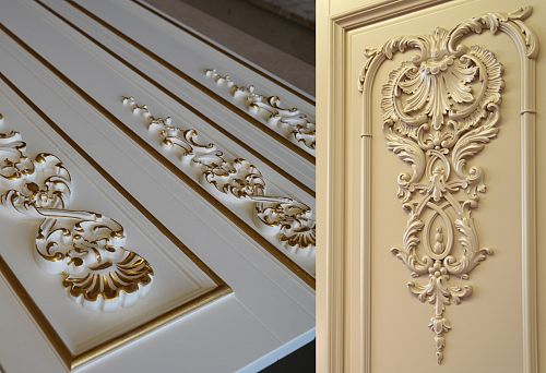 Carved classic decor on the facade of a wooden kitchen set.