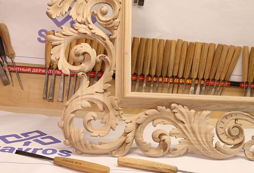 Carved, unpainted wooden frame with exquisite ornament in the workshop