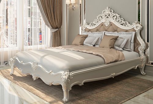 White bed made of solid wood with carved headboard and soft upholstery