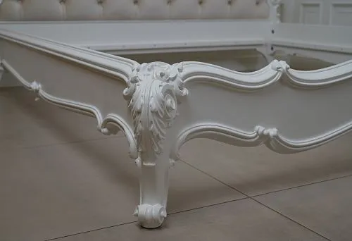 Carved Furniture Details: Carved Elements on a White Bed Frame, Executed with High Detailing.