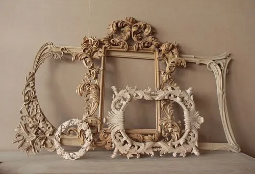 Elegant wooden frame with delicate handcrafted ornament.
