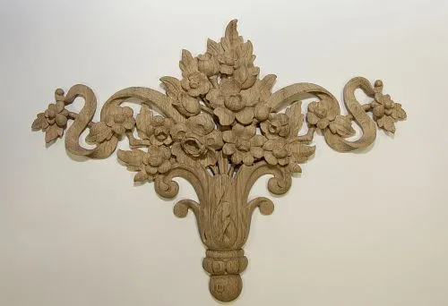 Decorative carved wooden element in the form of a floral composition