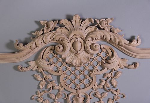 Decorative carved inlay of light wood with floral and botanical motifs