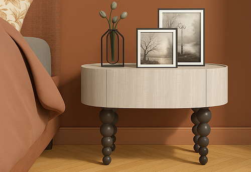 Modern bedside table on black legs with rounded shape and stylish design.