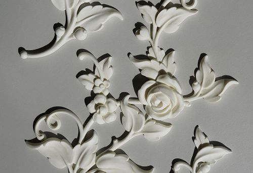 Stucco decoration on the ceiling &mdash; a set of white decorative elements made of polyurethane with floral-leaf ornament for architectural transformation of the ceiling.