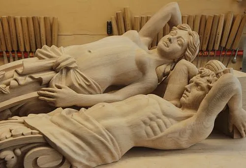 Carved decorative elements with realistic details, reflecting artistic carving.