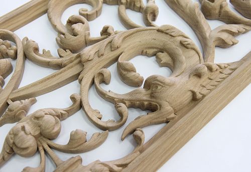 Decorative carved element from natural wood with a mythical animal motif for modern interiors