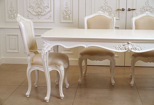 White carved solid wood chairs with soft upholstery