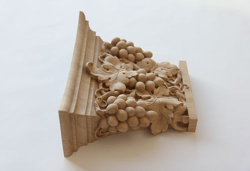 Carved decorative element with grapevine from natural wood