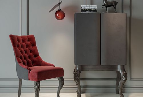 Modern chair with soft velvet upholstery and carved wooden legs against a minimalist interior