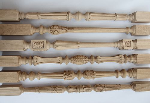 Set of carved wooden balusters of different heights and shapes, demonstrating a variety of styles
