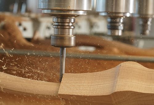 Wood processing on a high-precision machine, the process of creating furniture details from natural wood.