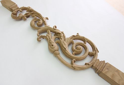 Carved wooden baluster with elegant ornament and decorative carving.