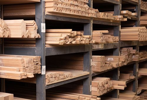 Shelves with neatly arranged wooden blanks and profiles of various shapes and sizes