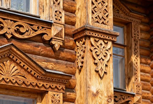Carved wooden facade decor for exterior house finishing with columns and window trims
