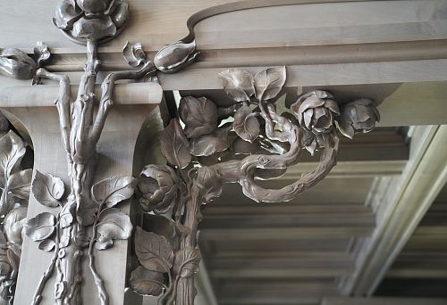 Decorative carved oak element in the shape of roses and branches &mdash; handmade