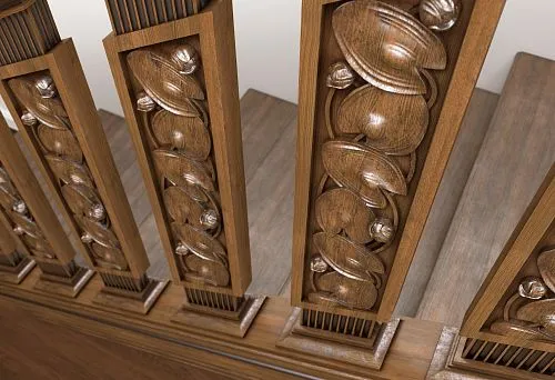 Wooden balusters with relief carving on the staircase