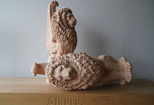 Carved oak lion figures &mdash; handcrafted with deep relief in manes and anatomical precision