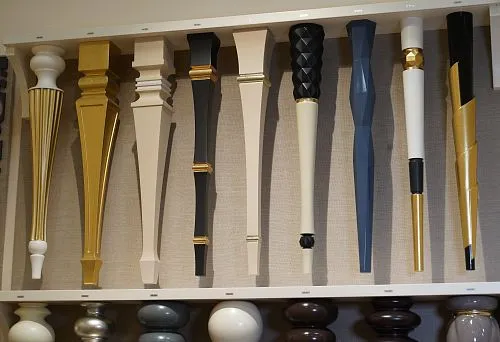 Set of painted and decorated wooden legs for tables, showcasing a variety of shapes and styles.