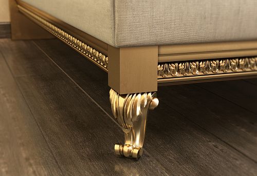 Decorative furniture leg with carved pattern and gold finish, giving furniture a luxurious and elegant look.