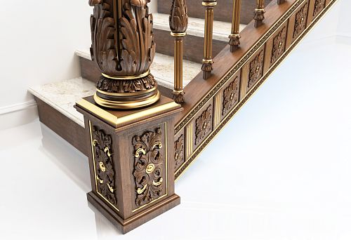Carved base of wooden column with golden accents against marble staircase
