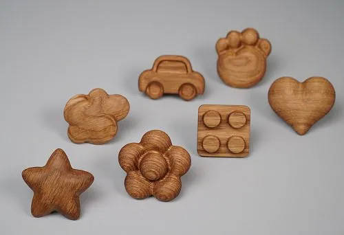 Original wooden handles for furniture in the shape of toys.