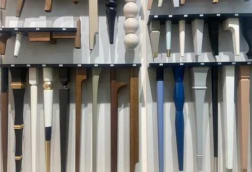 Collection of diverse furniture legs with different shapes, colors, and decorative finishes.