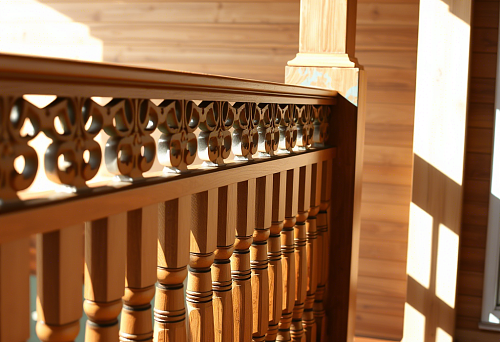 Modern MDF balusters for terrace fencing, combined with wooden cladding