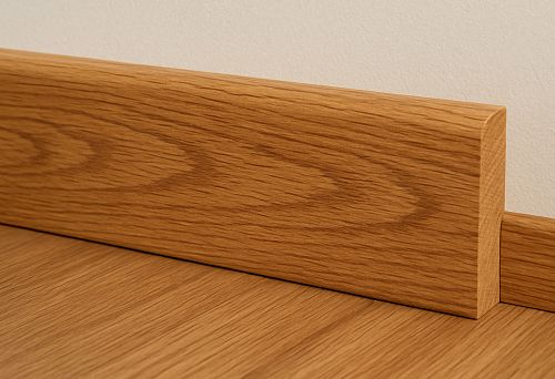 Oak skirting board from solid wood with natural wood texture in modern interior