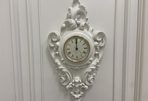 Decorative wooden clocks with refined baroque elements.