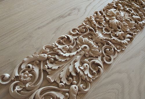 Elegant carved ornament with floral and botanical motifs, handcrafted.