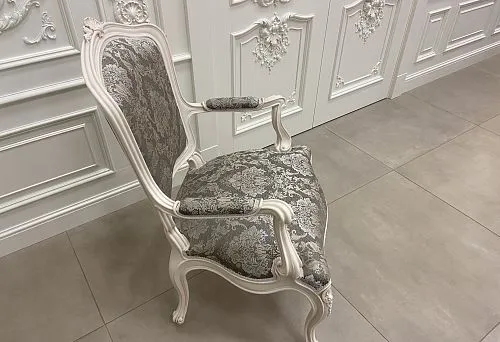 Classic chair with elegant carving and fabric upholstery, perfectly suited for an elegant interior.