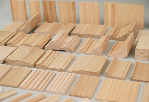 Samples of natural oak skirting boards with various profiles and shapes for interiors